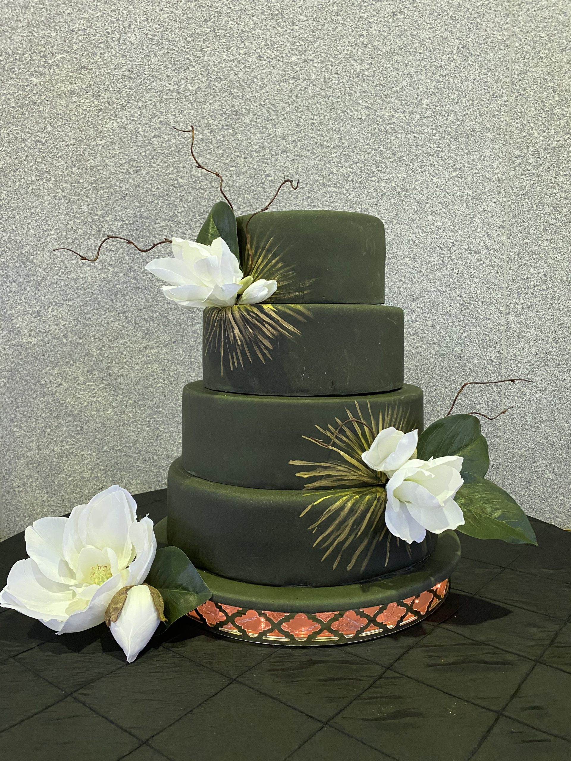 A beautiful 4-tier custom wedding cake with painted fondant and live flowers from Village Patisserie in Toledo, Ohio