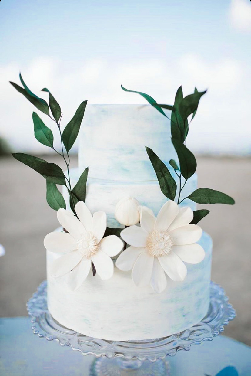 A beautiful 3-tier custom wedding cake with watercolor finish and wooden flowers from Village Patisserie in Toledo, Ohio