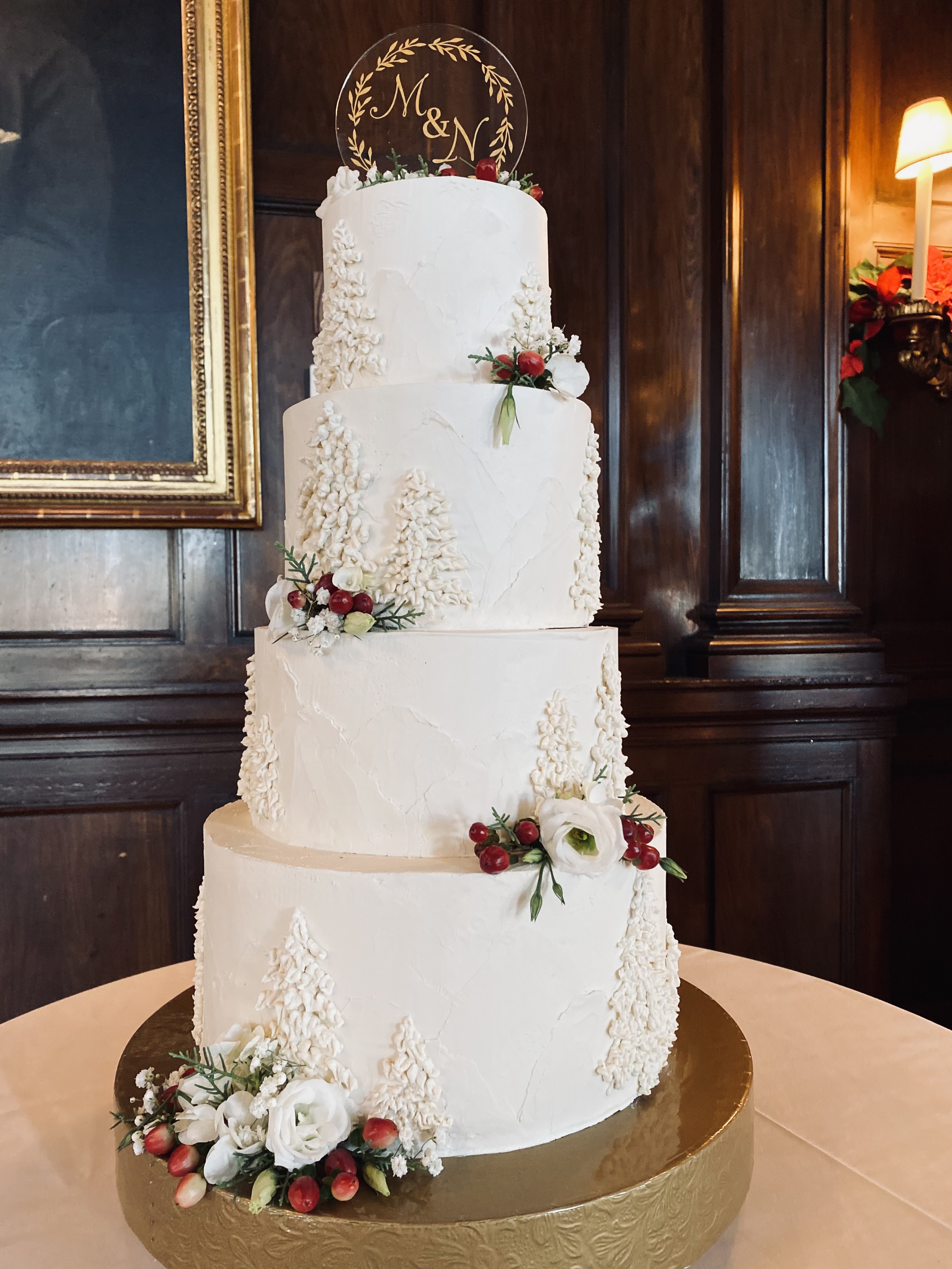 A beautiful 4-tier custom wedding cake with buttercream detail and live flowers from Village Patisserie in Toledo, Ohio