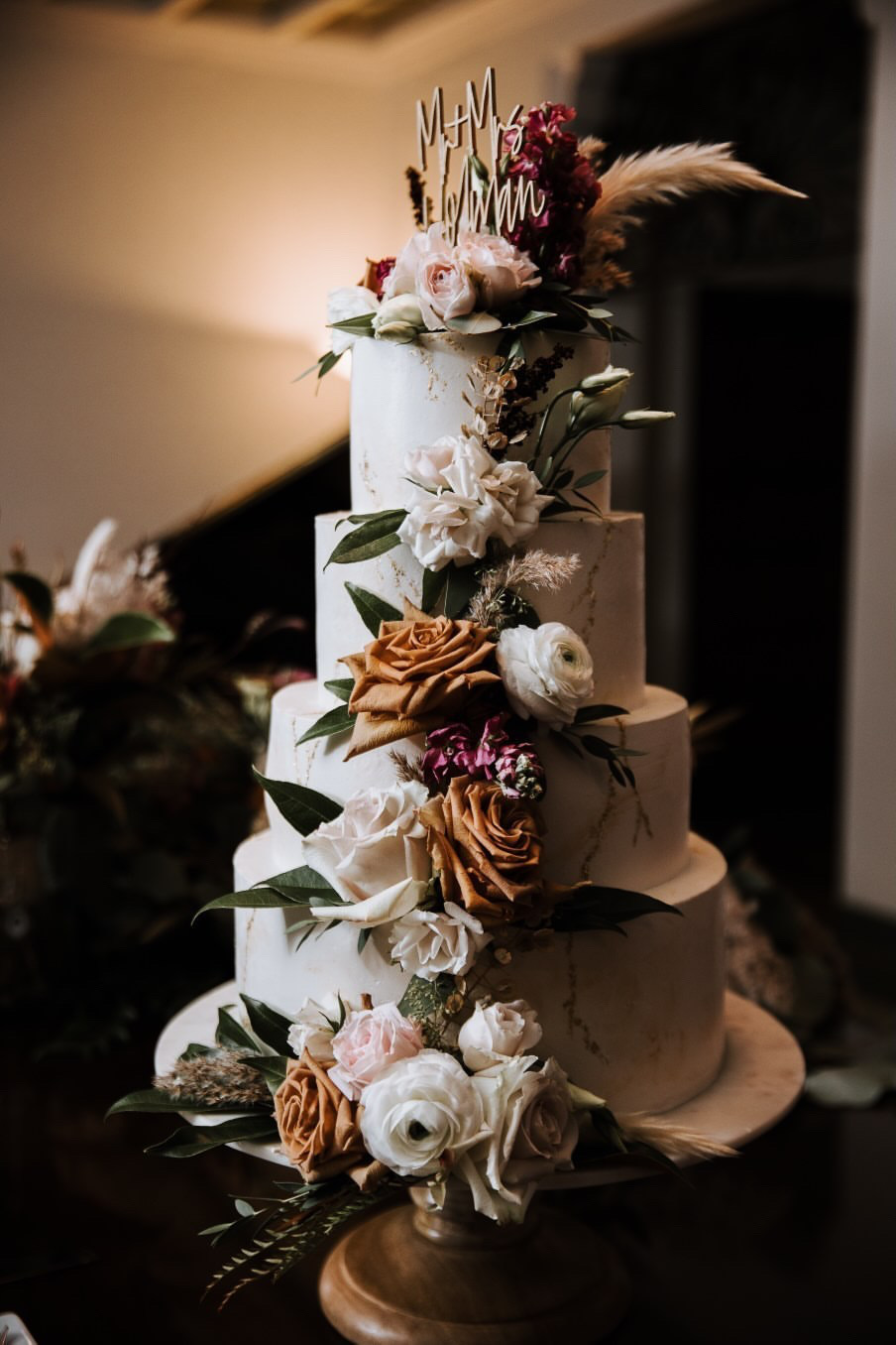 An elegant 4-tier custom wedding cake with live flowers from Village Patisserie in Toledo, Ohio