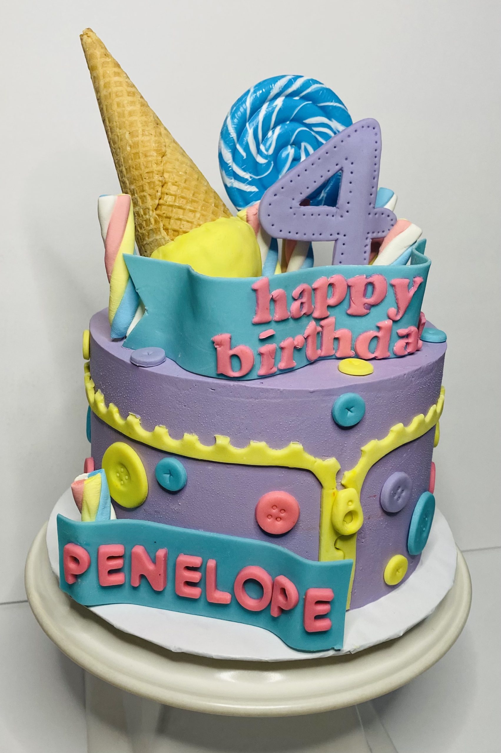 A custom children's birthday cake with hand-crafted fondant decorations from Village Patisserie in Toledo, Ohio