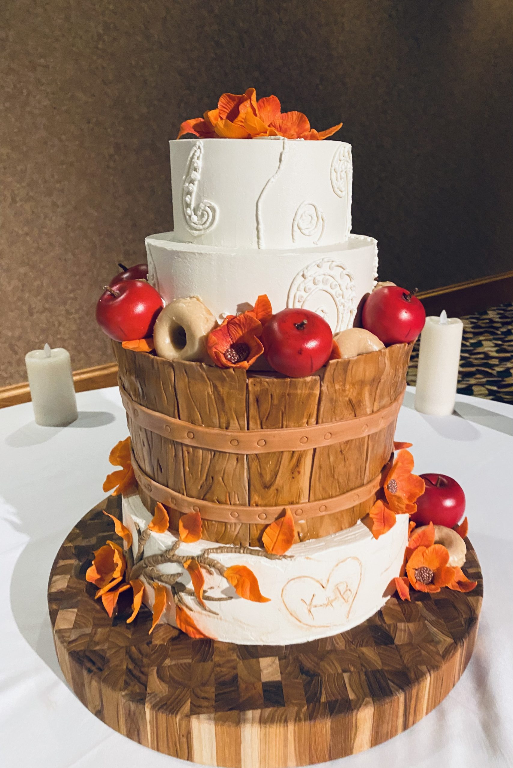 A beautiful 4-tier custom wedding cake with hand-piped buttercream detail, wood-look fondant, and fondant flowers from Village Patisserie in Toledo, Ohio