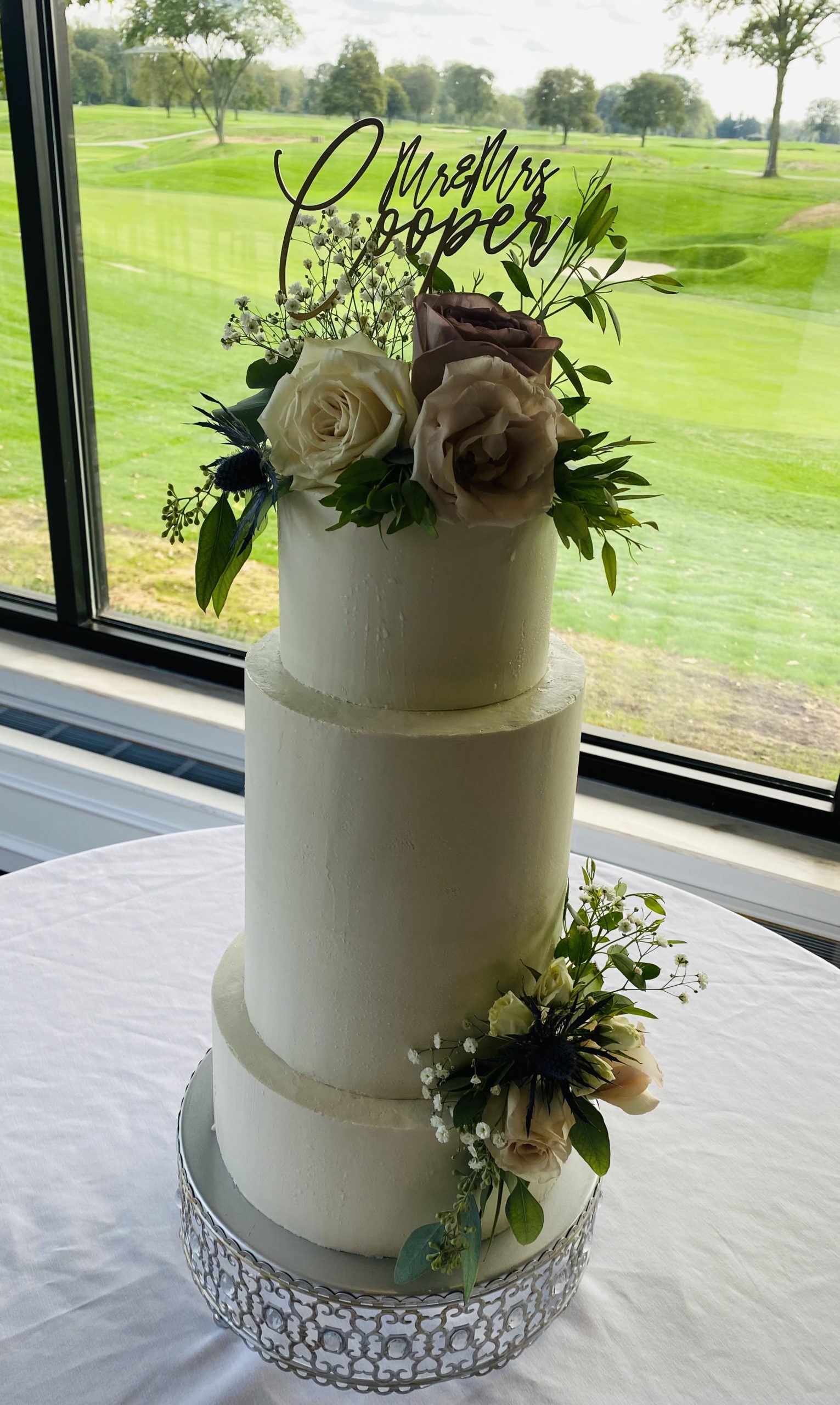 A beautiful 3-tier custom wedding cake with live flowers from Village Patisserie in Toledo, Ohio